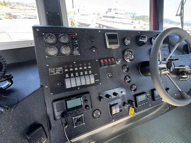 Slide: The Image of Control panel of a 2020 Aluminum Cruiser 42' Trawler with gauges and steering wheel. - 19