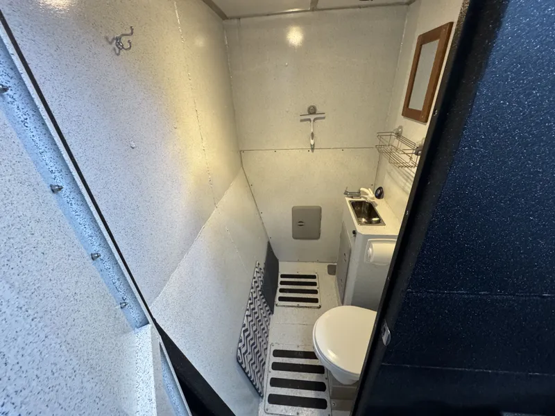 Slide: The Image of 2020 Aluminum Cruiser 42' Trawler bathroom with compact sink, toilet, and mirror. - 23