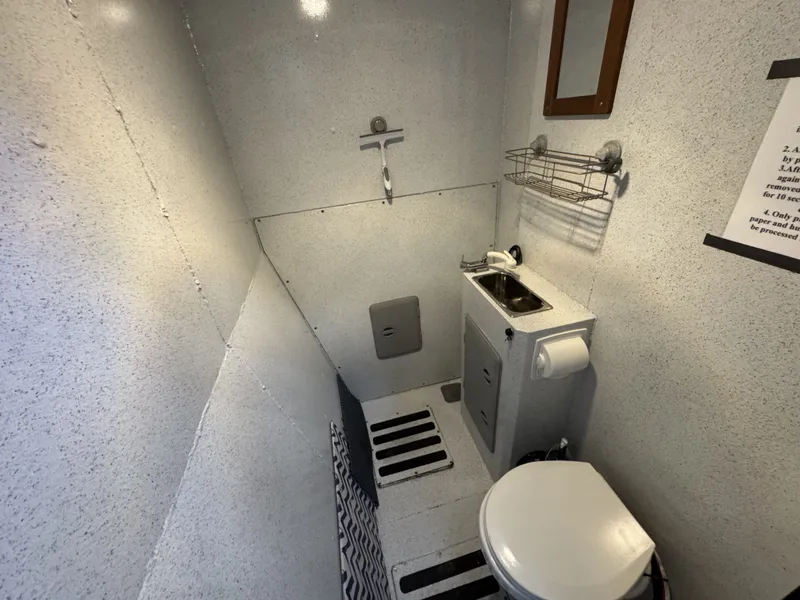 Slide: The Image of Bathroom interior of a 2020 Aluminum Cruiser 42' Aluminum Trawler, featuring sink and toilet. - 24