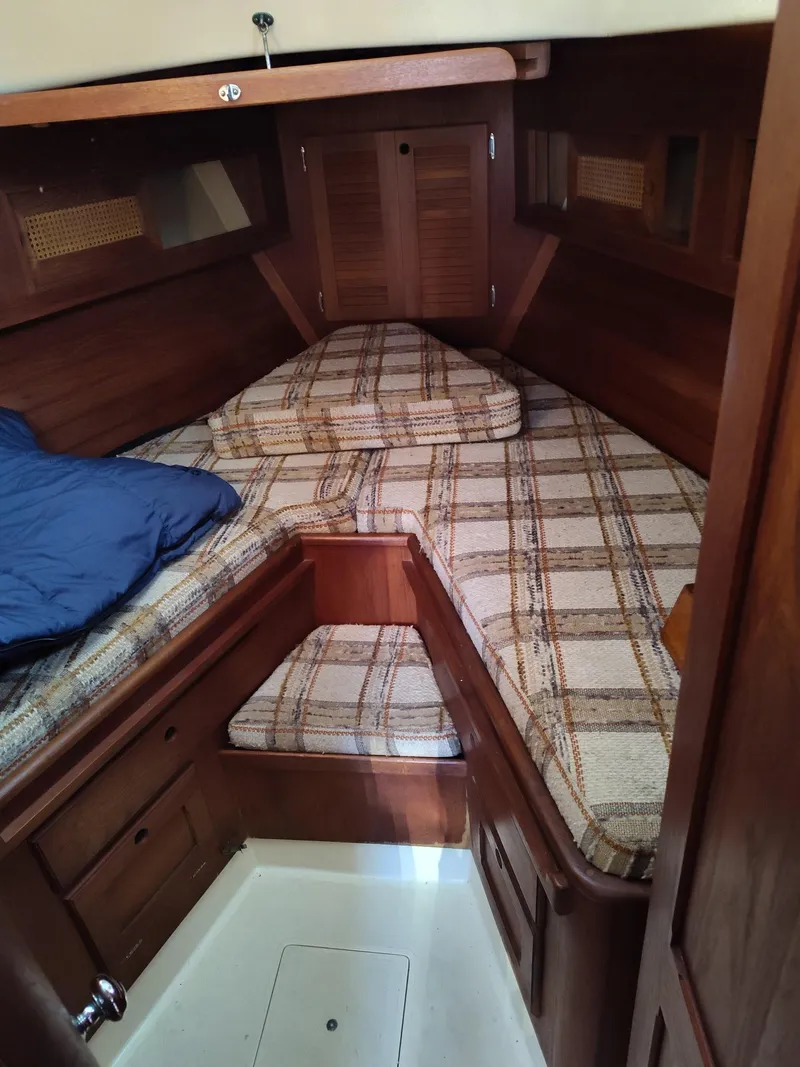 Slide: The Image of 1982 Bristol 35.5 sailboat cabin with plaid cushions and wooden interior. - 13