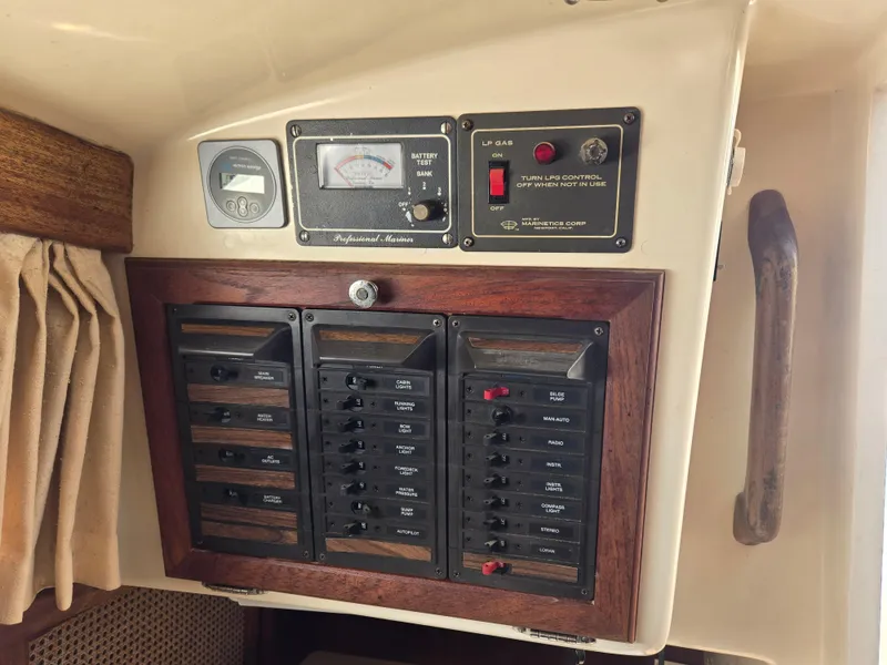 Slide: The Image of Electrical control panel on a 1982 Bristol 35.5 sailboat, featuring switches and gauges. - 14