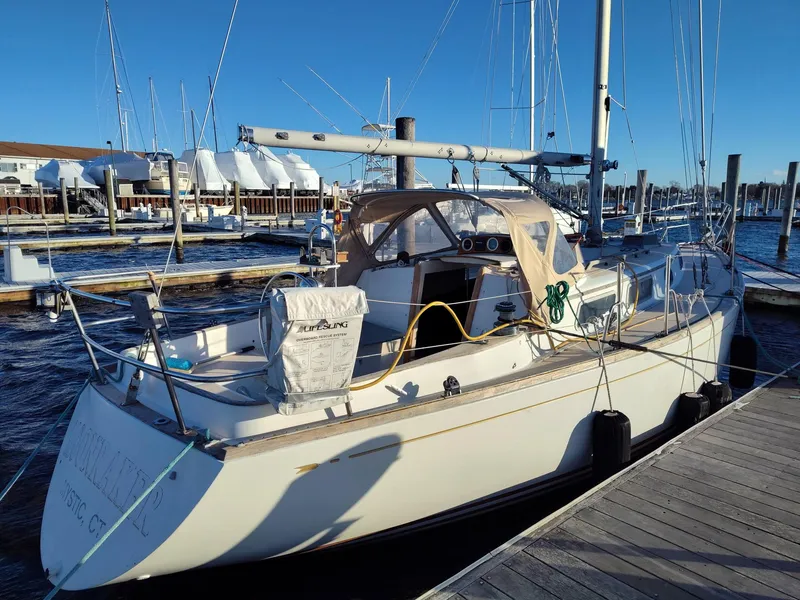 Slide: The Image of 1982 Bristol 35.5 sailboat docked at marina under clear blue sky. - 2