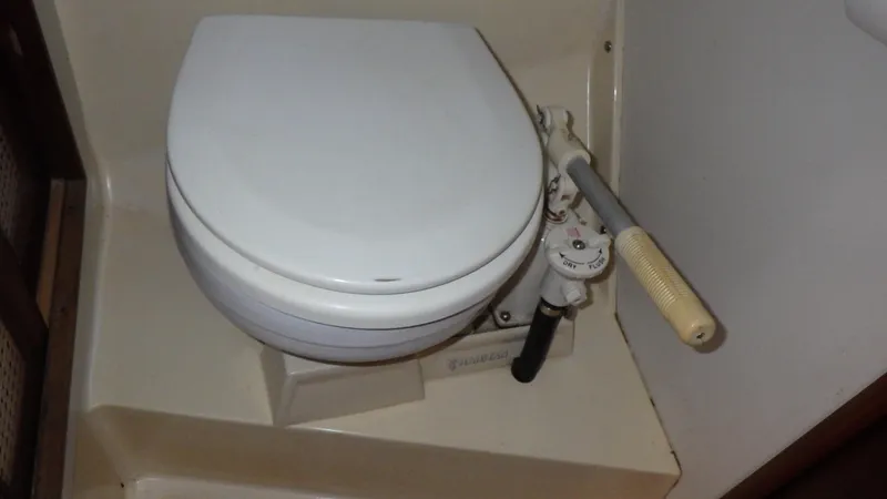 Slide: The Image of Marine toilet with manual pump in a 1982 Bristol 35.5 boat bathroom. - 20