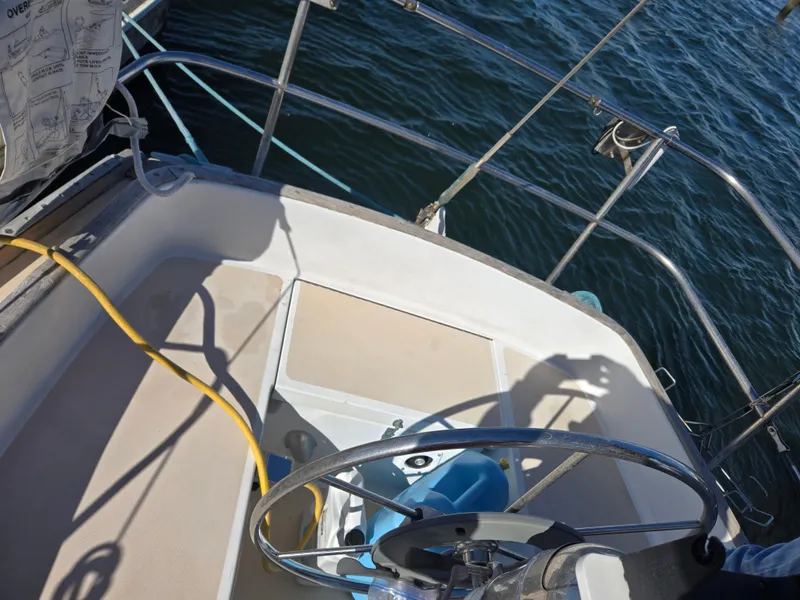 Slide: The Image of Cockpit of 1982 Bristol 35.5 sailboat with steering wheel and ocean view. - 6