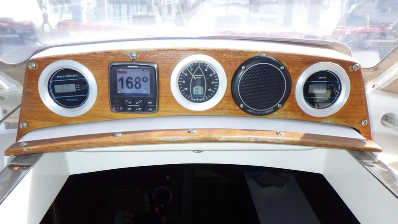 Slide: The Image of 1982 Bristol 35.5 boat dashboard with navigation instruments and wooden panel. - 9