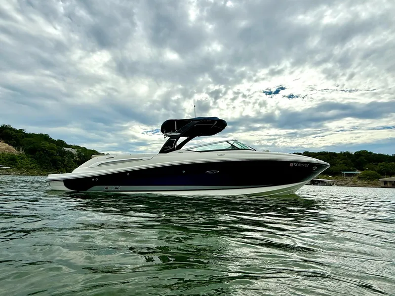 The Image of 2013 Sea Ray 250 SLX boat on water under cloudy sky. - 1