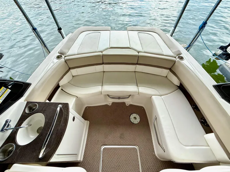 Slide: The Image of Interior of 2013 Sea Ray 250 SLX boat with seating and sink, docked on water. - 26