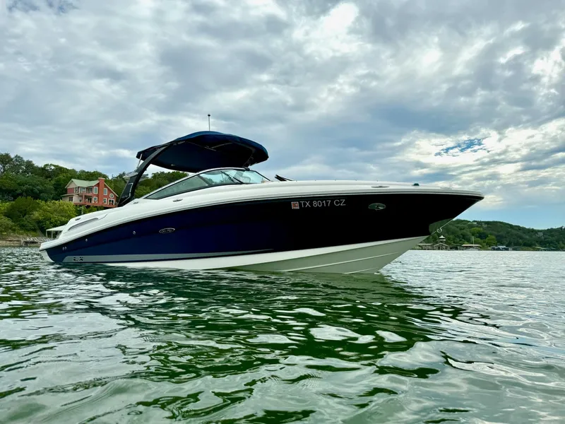Slide: The Image of 2013 Sea Ray 250 SLX boat on a lake under cloudy skies. - 3