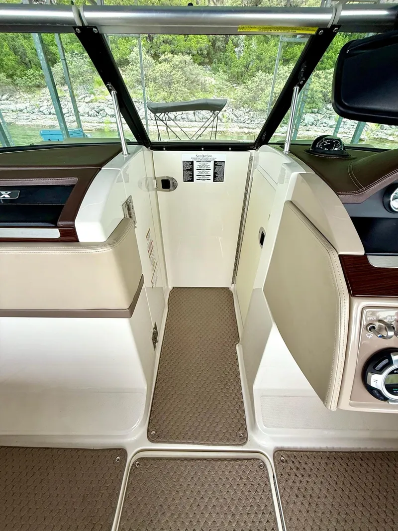 Slide: The Image of Interior view of a 2013 Sea Ray 250 SLX boat, featuring beige and brown accents. - 35