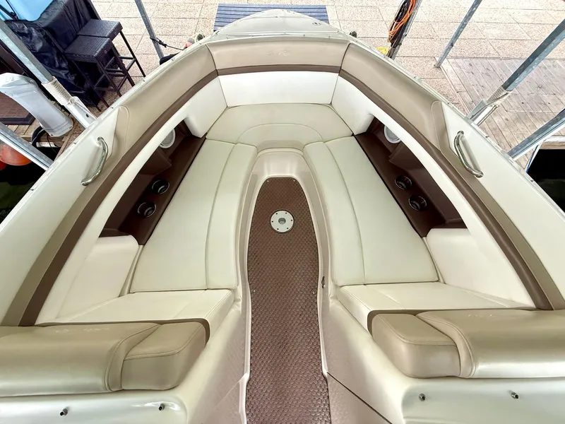 Slide: The Image of Interior of 2013 Sea Ray 250 SLX boat with beige seating and cup holders. - 37