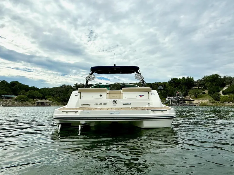 Slide: The Image of 2013 Sea Ray 250 SLX boat on calm water, scenic background. - 4