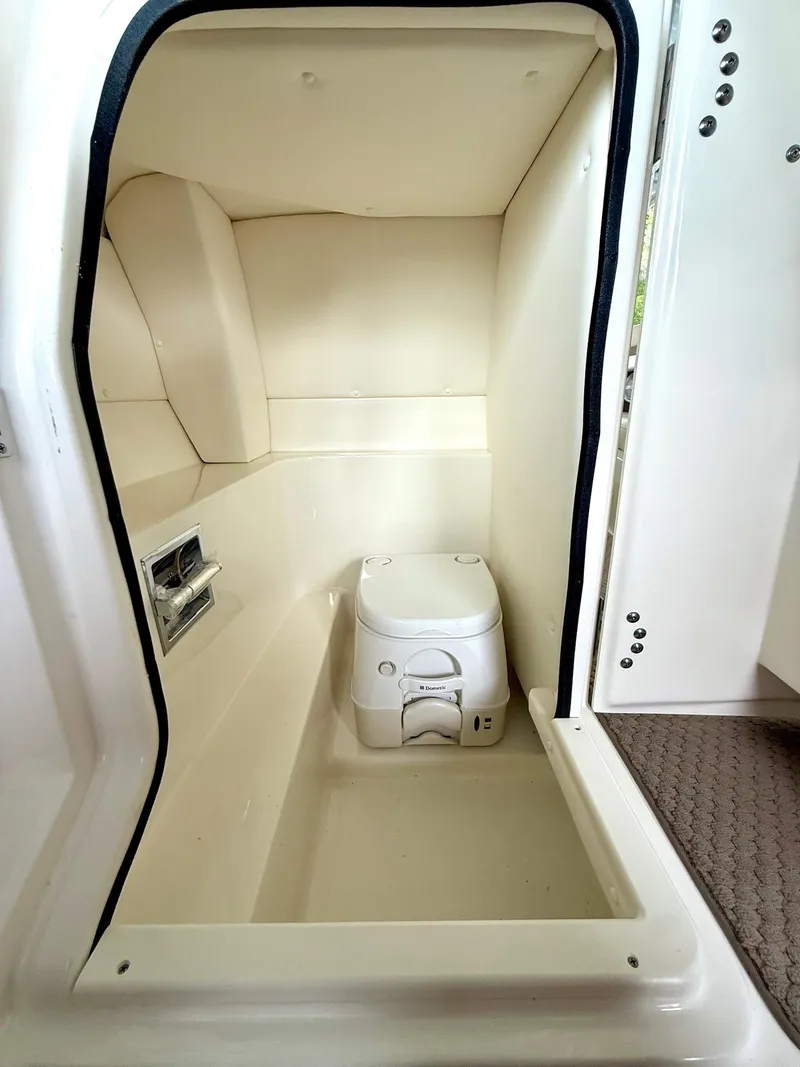 Slide: The Image of Interior of 2013 Sea Ray 250 SLX boat with compact marine toilet. - 40