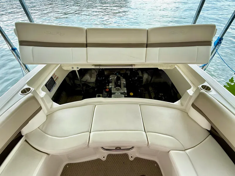 Slide: The Image of 2013 Sea Ray 250 SLX boat engine compartment with open seating, docked on water. - 42