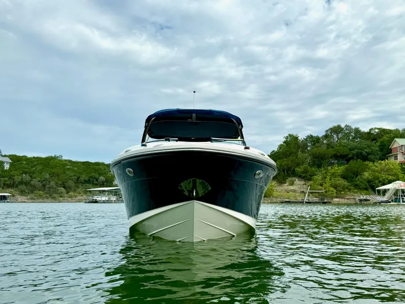 Slide: The Image of 2013 Sea Ray 250 SLX boat on a lake with scenic background. - 5