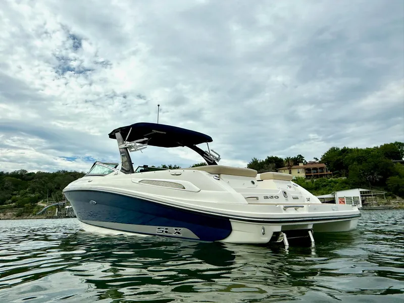 Slide: The Image of 2013 Sea Ray 250 SLX boat on water, cloudy sky background. - 8