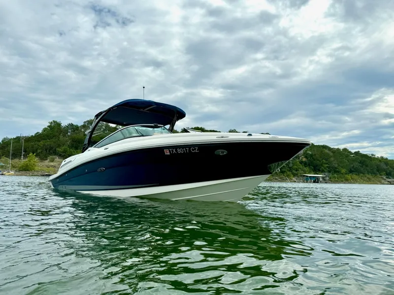 Slide: The Image of 2013 Sea Ray 250 SLX boat on a lake under cloudy skies. - 9