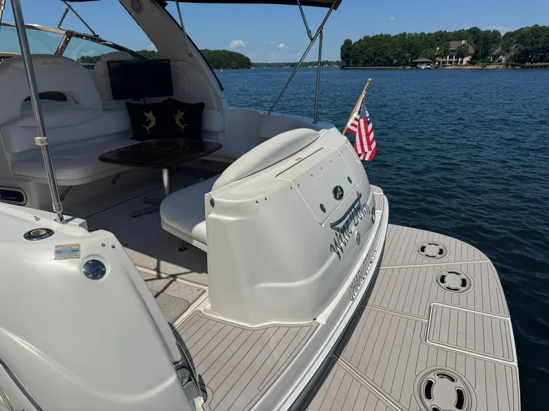 Slide: The Image of 2001 Sea Ray 380 Sundancer yacht on a serene lake with American flag. - 12
