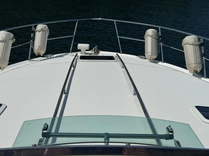 Slide: The Image of Bow view of 2001 Sea Ray 380 Sundancer yacht with fenders and railing. - 14
