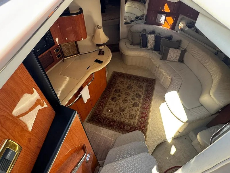 Slide: The Image of Interior of 2001 Sea Ray 380 Sundancer with elegant seating and wooden cabinetry. - 16