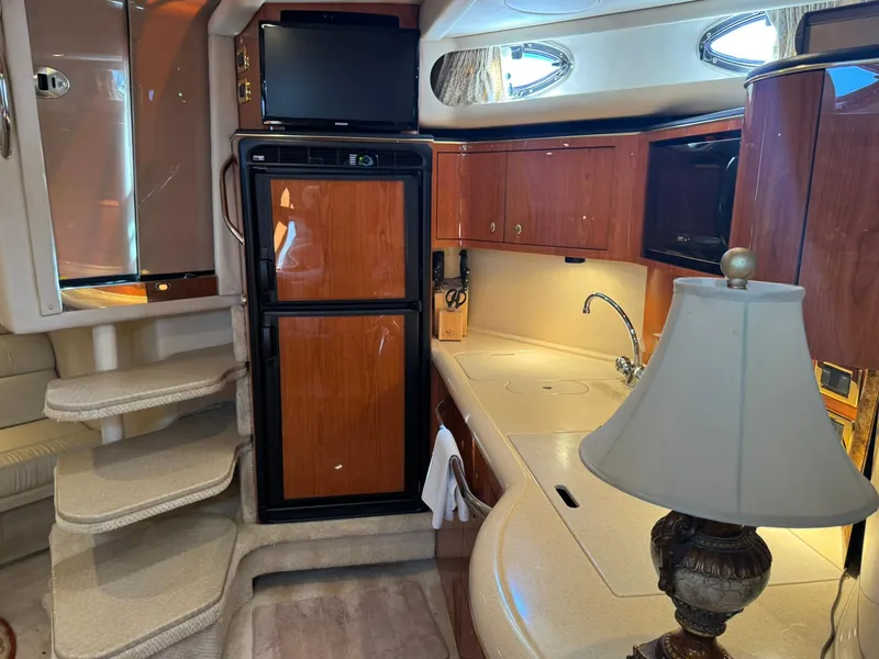 Slide: The Image of Interior of 2001 Sea Ray 380 Sundancer yacht with kitchen and stairs. - 26