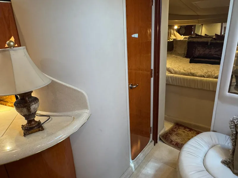 Slide: The Image of Interior of 2001 Sea Ray 380 Sundancer yacht with cozy bedroom and elegant lamp. - 27