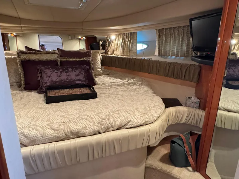 Slide: The Image of Luxurious cabin interior of 2001 Sea Ray 380 Sundancer yacht with cozy bedding and TV. - 29