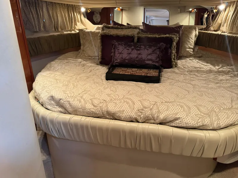 Slide: The Image of Luxurious cabin interior of 2001 Sea Ray 380 Sundancer with plush bedding and elegant decor. - 30