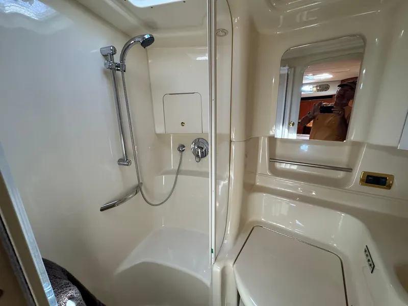 Slide: The Image of Bathroom interior of 2001 Sea Ray 380 Sundancer yacht, featuring shower and mirror. - 31