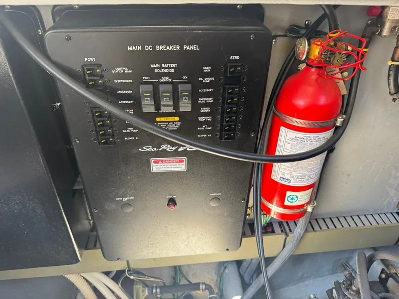 Slide: The Image of Main DC breaker panel and fire extinguisher on 2001 Sea Ray 380 Sundancer boat. - 40