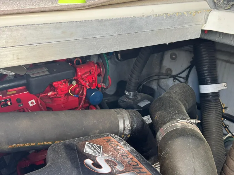 Slide: The Image of Engine compartment of a 2001 Sea Ray 380 Sundancer, featuring red engine components and hoses. - 41