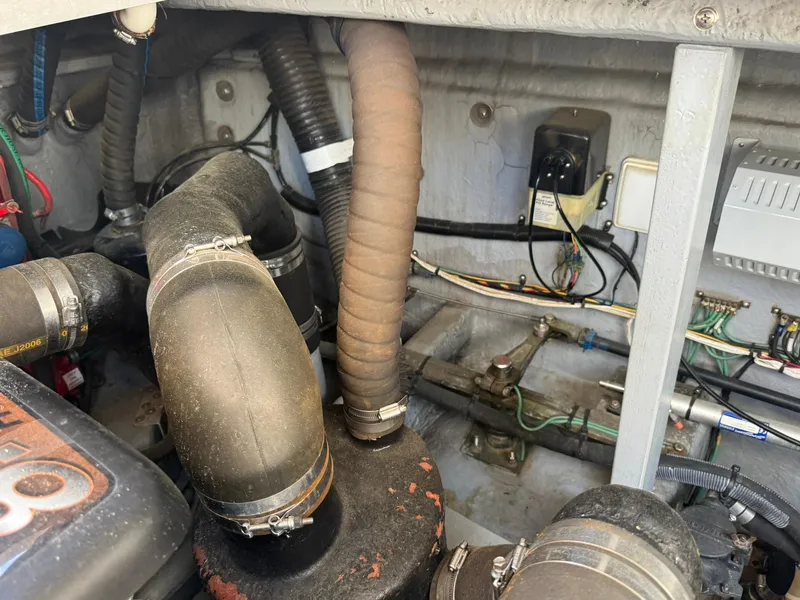 Slide: The Image of Engine compartment of a 2001 Sea Ray 380 Sundancer with visible hoses and wiring. - 42