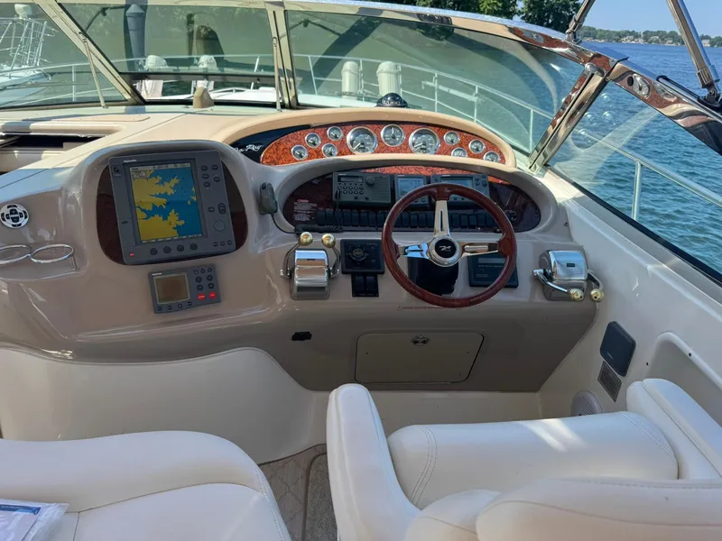 Slide: The Image of Helm of 2001 Sea Ray 380 Sundancer with navigation equipment and steering wheel. - 5