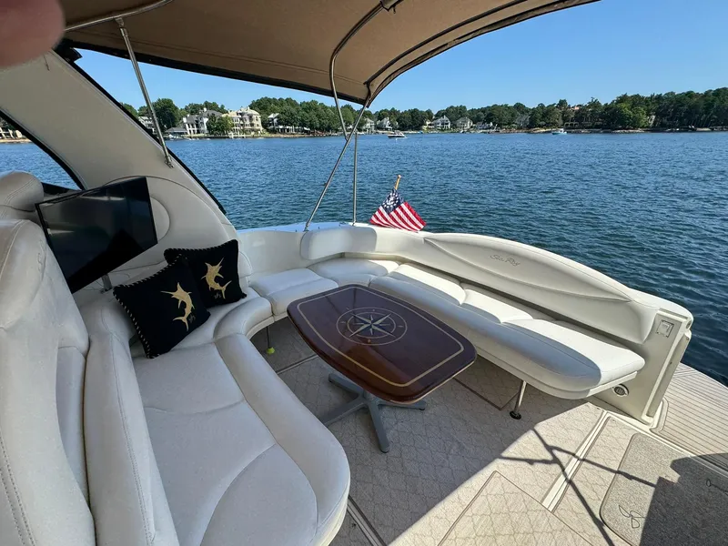 Slide: The Image of Luxurious 2001 Sea Ray 380 Sundancer yacht interior with seating, table, and lake view. - 9