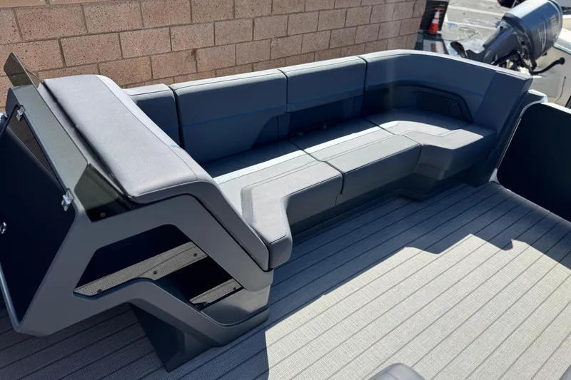 Slide: The Image of 2025 Manitou Explore 24 Navigator boat interior with sleek seating design. - 10