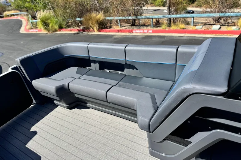 Slide: The Image of Luxurious seating on the 2025 Manitou Explore 24 Navigator boat, featuring sleek gray upholstery. - 11