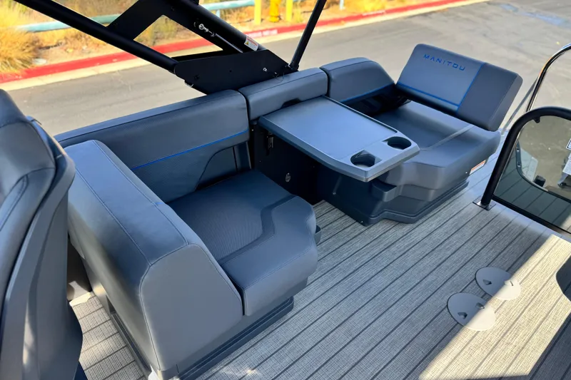 Slide: The Image of 2025 Manitou Explore 24 Navigator boat interior with seating and table. - 13