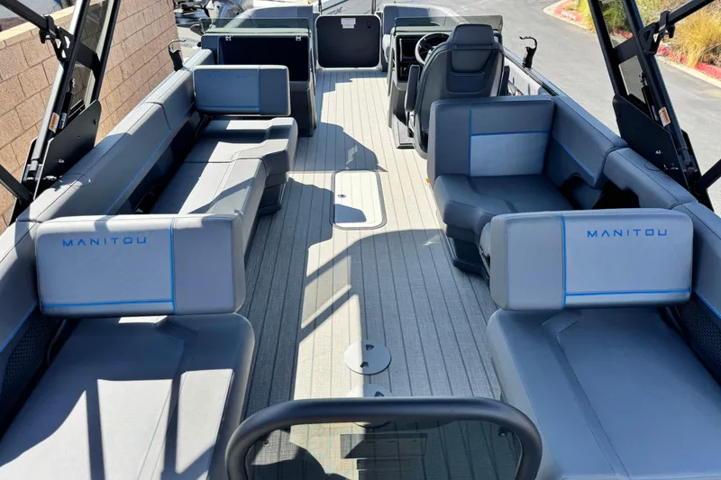 Slide: The Image of 2025 Manitou Explore 24 Navigator boat interior with spacious seating and modern design. - 19