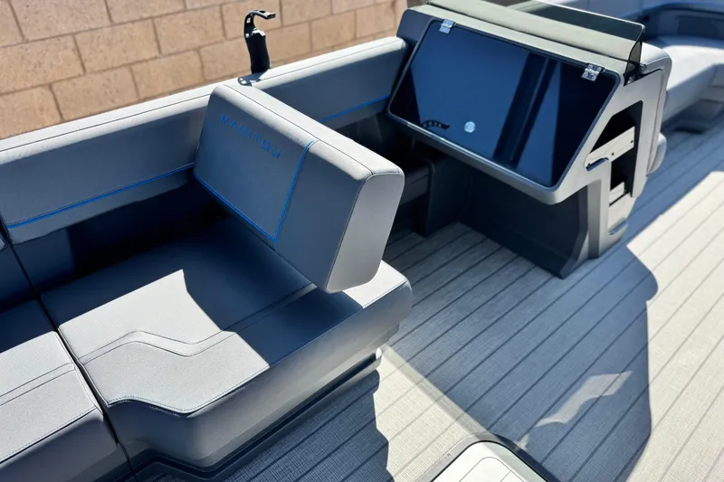 Slide: The Image of 2025 Manitou Explore 24 Navigator boat interior with sleek seating and modern design. - 21