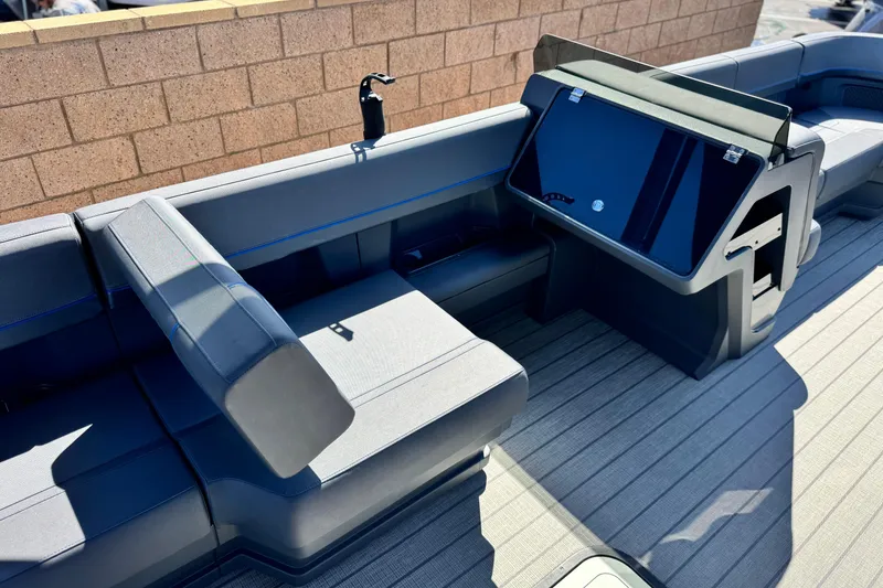 Slide: The Image of 2025 Manitou Explore 24 Navigator boat interior with sleek seating and modern console design. - 22