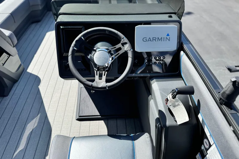 Slide: The Image of 2025 Manitou Explore 24 Navigator boat dashboard with Garmin navigation system. - 25