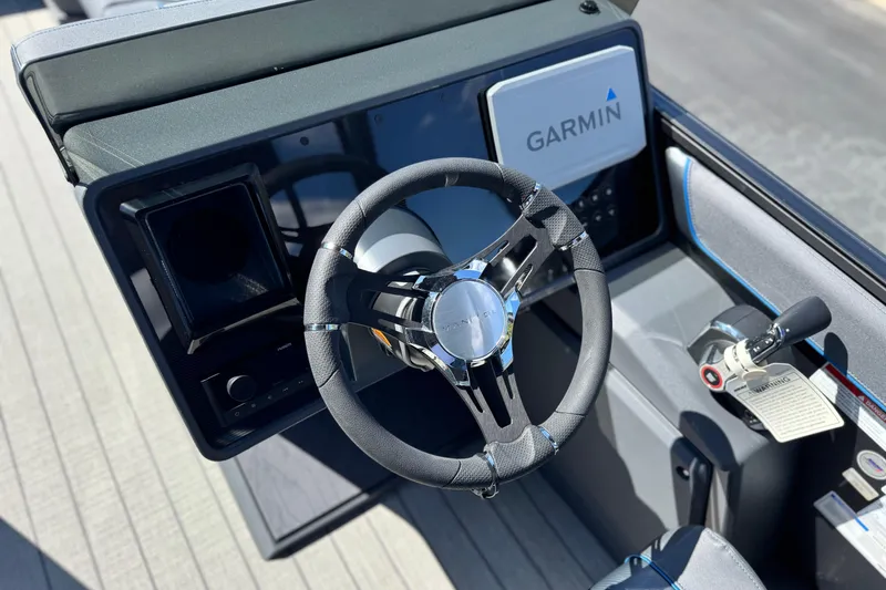 Slide: The Image of Steering console of 2025 Manitou Explore 24 Navigator with Garmin navigation system. - 26