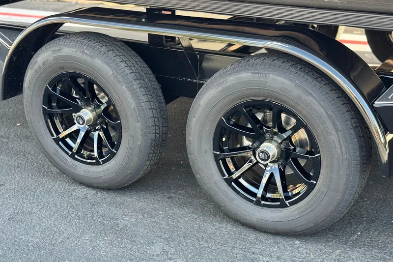 Slide: The Image of 2025 Manitou Explore 24 Navigator trailer wheels with sleek black rims. - 27
