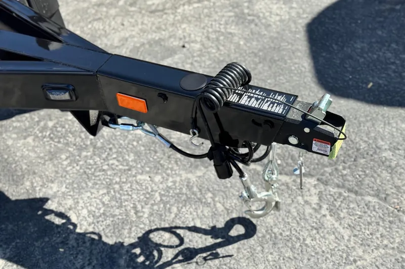 Slide: The Image of Trailer hitch of 2025 Manitou Explore 24 Navigator on asphalt surface. - 28