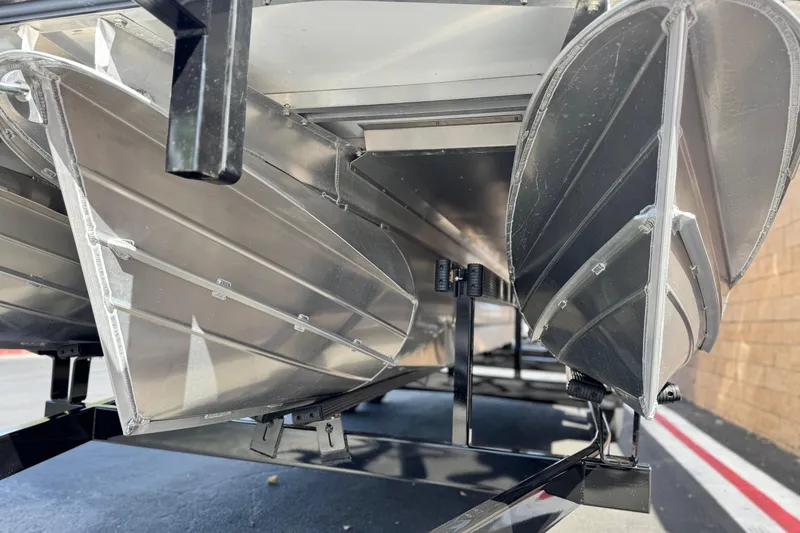 Slide: The Image of Underneath view of 2025 Manitou Explore 24 Navigator pontoon boat on trailer. - 4