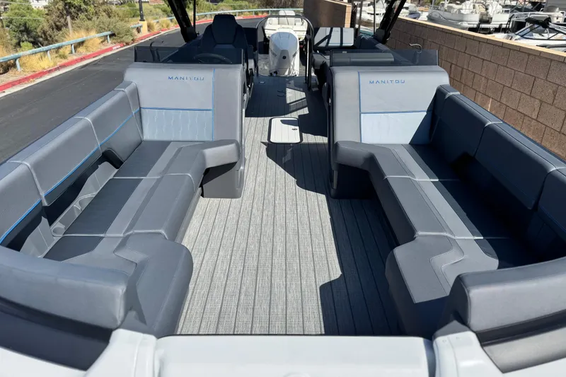 Slide: The Image of 2025 Manitou Explore 24 Navigator pontoon boat with spacious seating and modern design. - 8