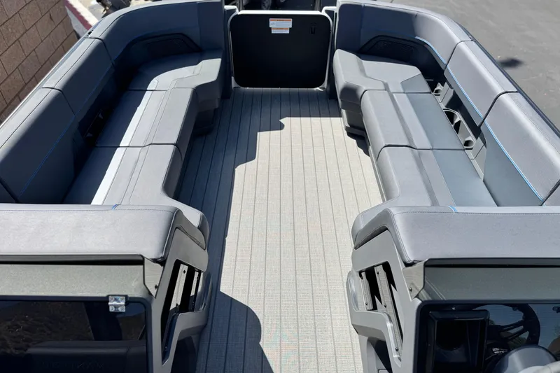 Slide: The Image of 2025 Manitou Explore 24 Navigator boat interior with spacious seating and modern design. - 9