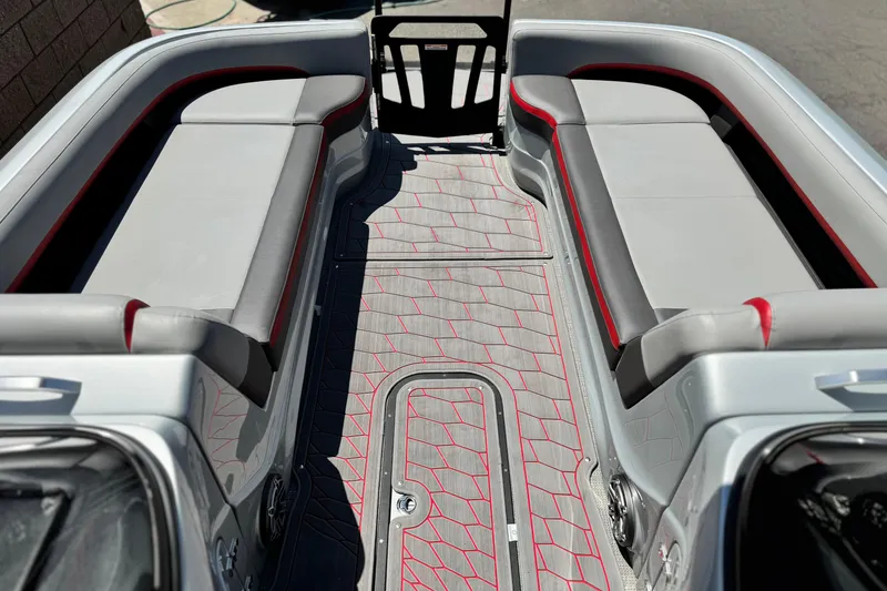 Slide: The Image of 2023 Manitou 25 XT RFXW boat interior with sleek seating and modern flooring design. - 12