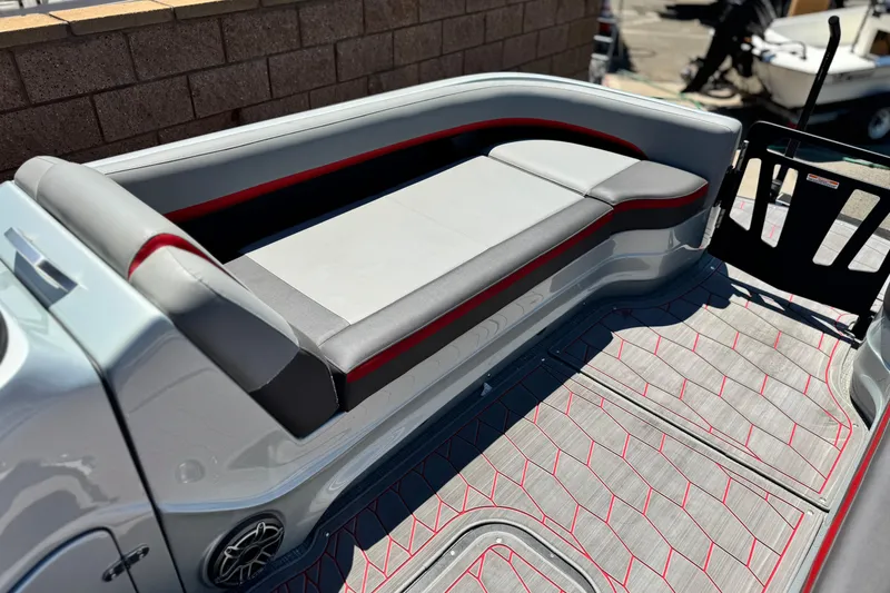 Slide: The Image of 2023 Manitou 25 XT RFXW boat interior with sleek seating and stylish flooring. - 13