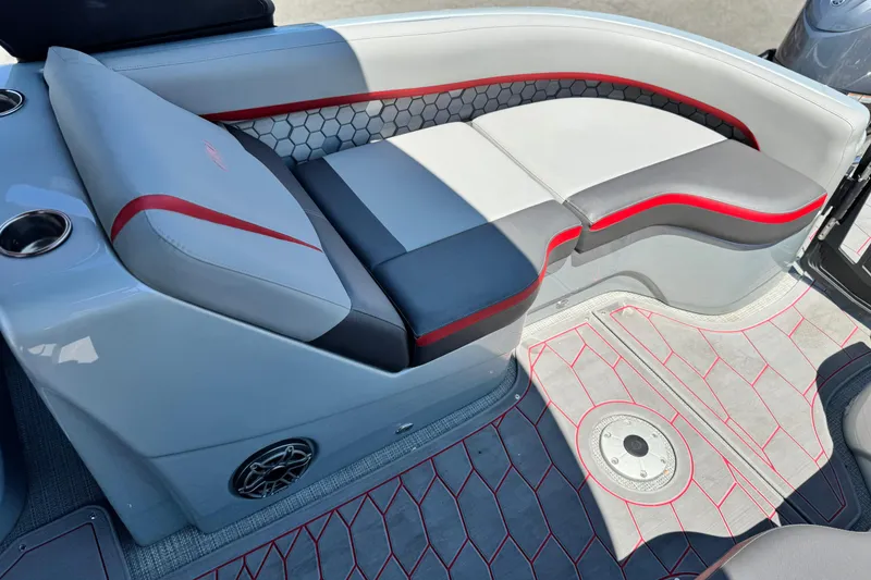 Slide: The Image of 2023 Manitou 25 XT RFXW boat interior with stylish seating and modern design. - 17