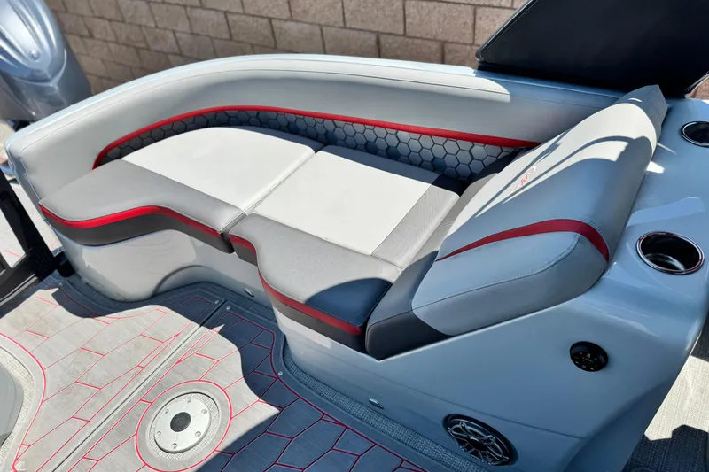 Slide: The Image of 2023 Manitou 25 XT RFXW boat interior with stylish seating and modern design. - 18